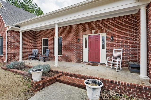 view of exterior entry featuring a porch