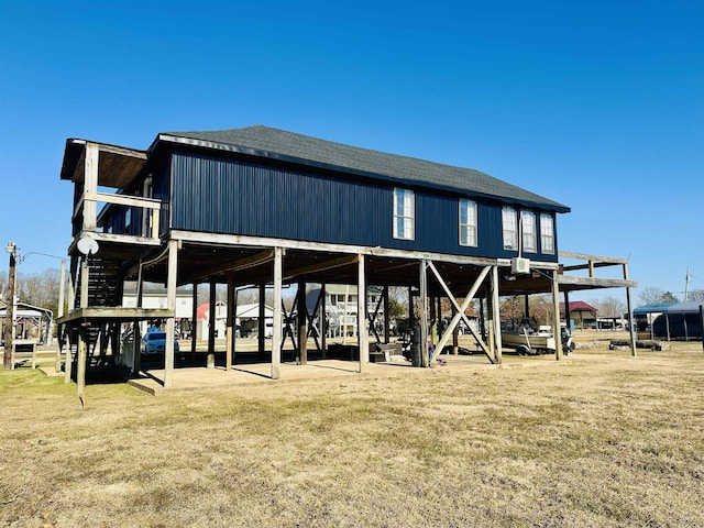 rear view of property featuring a yard