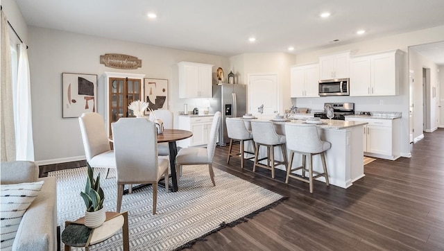 dining space with dark wood-type flooring