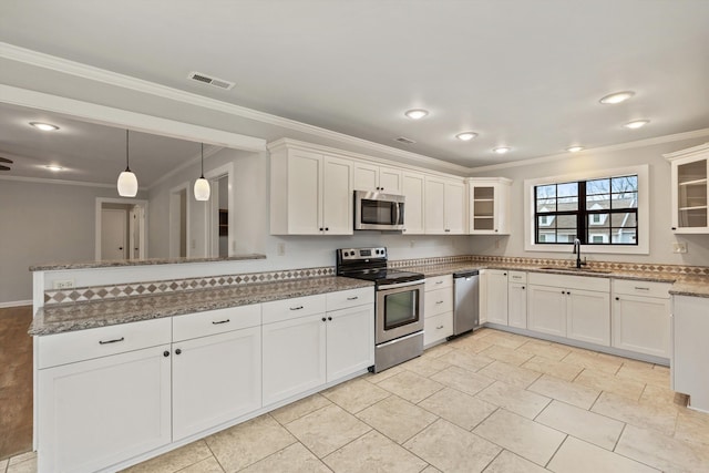 kitchen featuring stone counters, white cabinetry, sink, hanging light fixtures, and stainless steel appliances