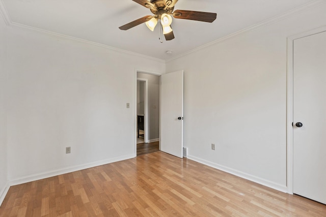 unfurnished room featuring ornamental molding, ceiling fan, and light wood-type flooring