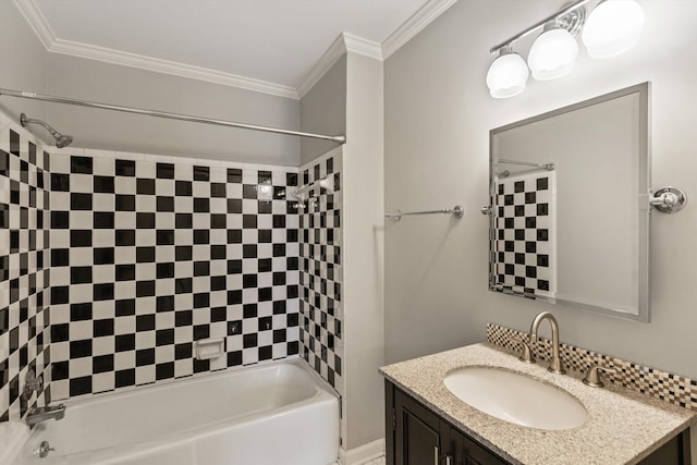 bathroom featuring ornamental molding, vanity, and tiled shower / bath