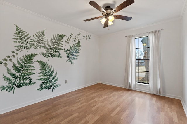 spare room with crown molding, light hardwood / wood-style floors, and ceiling fan