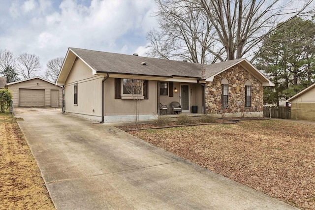 single story home featuring an outbuilding, a garage, and covered porch