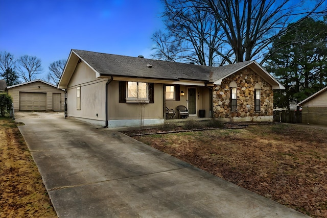 ranch-style house with a garage and an outdoor structure