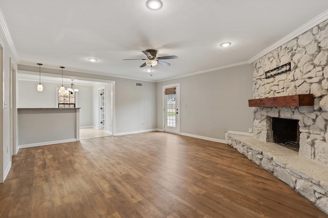 unfurnished living room featuring crown molding, ceiling fan, wood-type flooring, and a fireplace