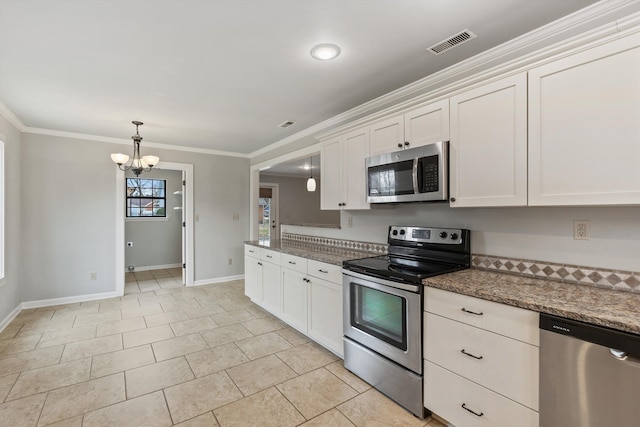 kitchen with appliances with stainless steel finishes, white cabinets, ornamental molding, light tile patterned floors, and an inviting chandelier