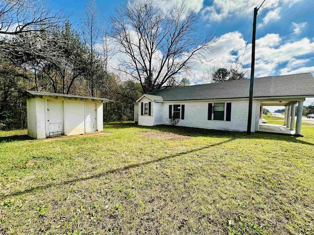 back of property with a shed and a lawn