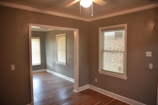 spare room with dark wood-type flooring and ceiling fan