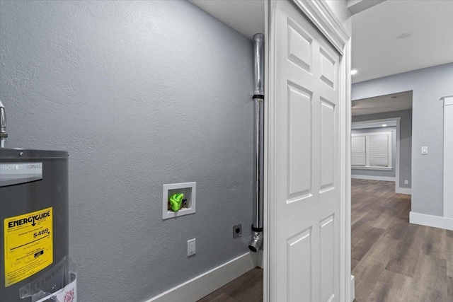 clothes washing area featuring washer hookup, dark hardwood / wood-style floors, water heater, and electric dryer hookup