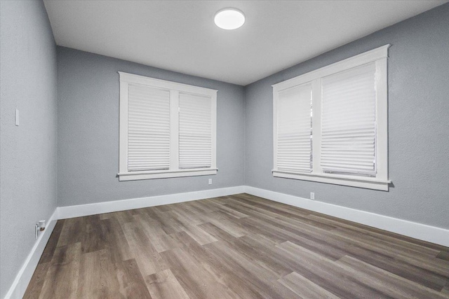 unfurnished room with wood-type flooring