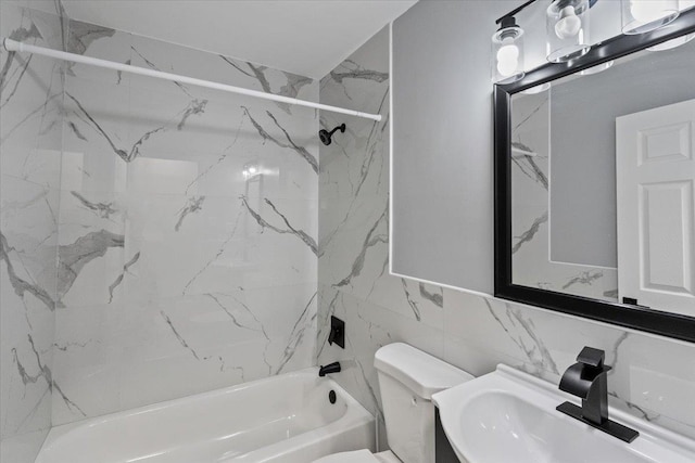 full bathroom featuring vanity, tile walls, toilet, and tiled shower / bath