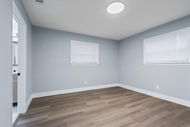 unfurnished room featuring hardwood / wood-style flooring