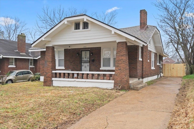 bungalow-style house featuring a front yard and covered porch