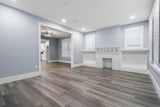 unfurnished living room featuring dark hardwood / wood-style floors and a fireplace