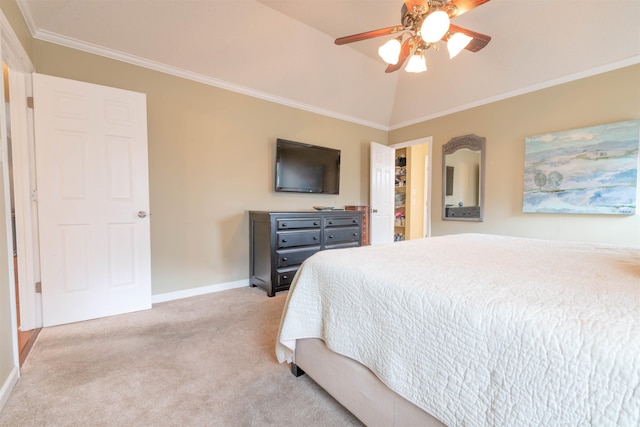 bedroom featuring crown molding, a spacious closet, vaulted ceiling, ceiling fan, and light colored carpet