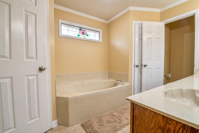 bathroom featuring a washtub, vanity, tile patterned floors, and ornamental molding