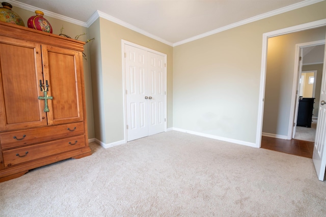 unfurnished bedroom featuring a closet, ornamental molding, and light carpet