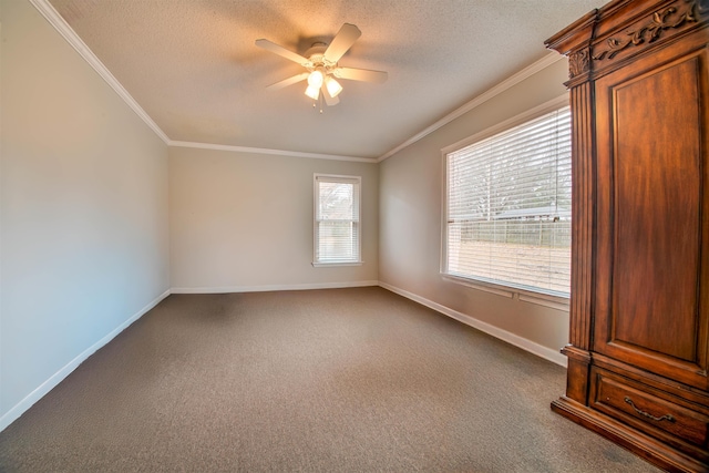 carpeted spare room with crown molding, ceiling fan, and a textured ceiling