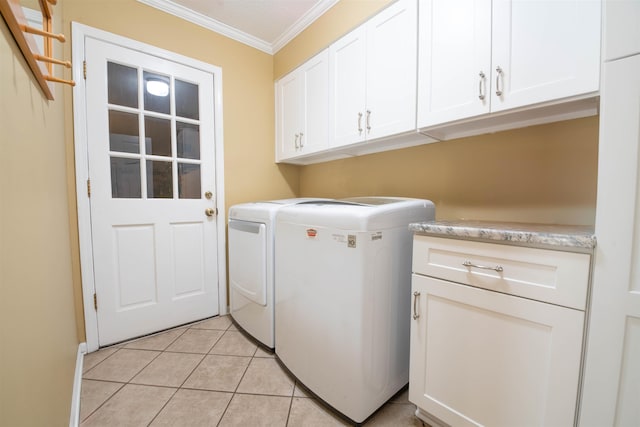 washroom featuring cabinets, ornamental molding, independent washer and dryer, and light tile patterned flooring