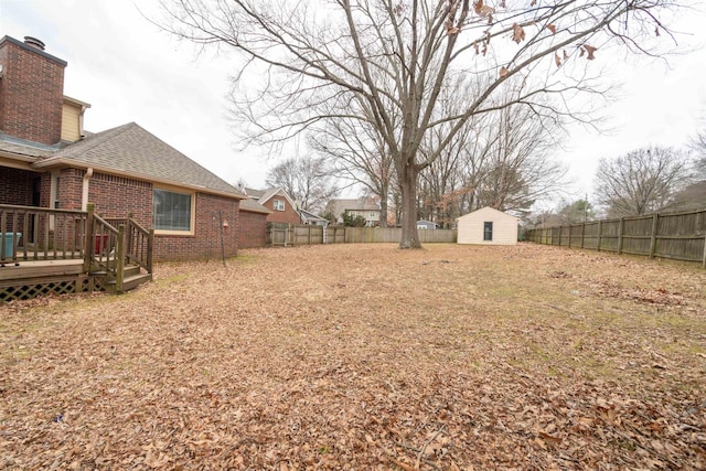 view of yard featuring a storage shed and a deck