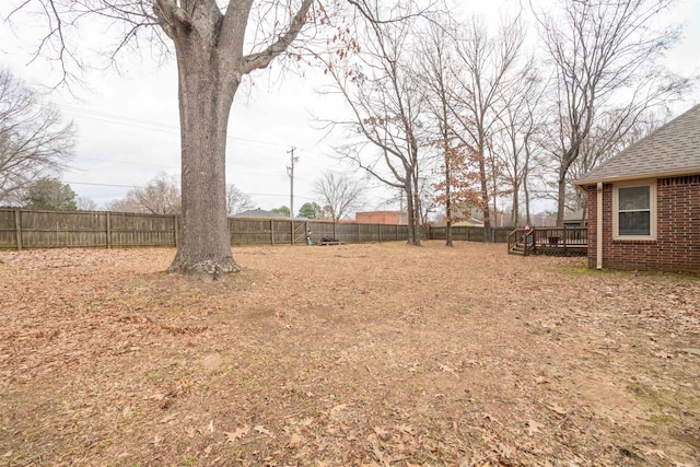 view of yard with a wooden deck