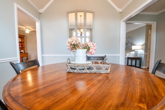 dining room with crown molding, vaulted ceiling, and ceiling fan