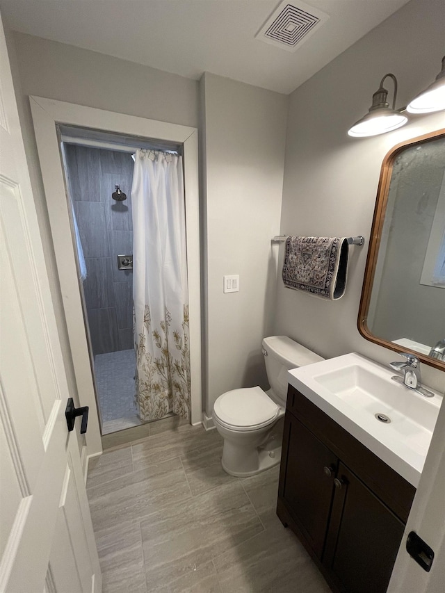 bathroom featuring vanity, a shower with curtain, and toilet