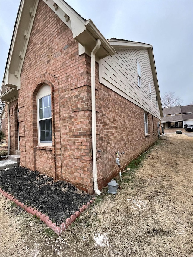 view of property exterior featuring brick siding