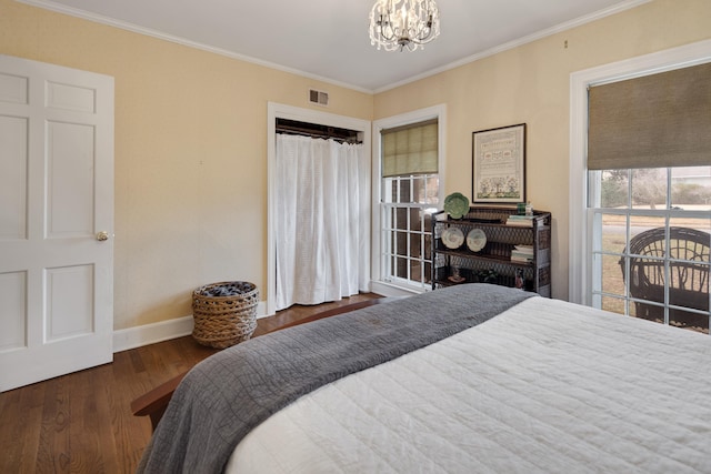 bedroom with ornamental molding, access to exterior, dark hardwood / wood-style floors, and a notable chandelier