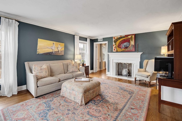 living room featuring ornamental molding and wood-type flooring