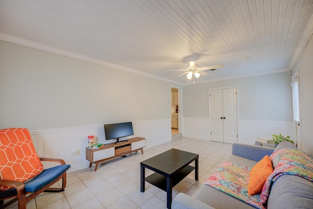 tiled living room with ornamental molding and ceiling fan