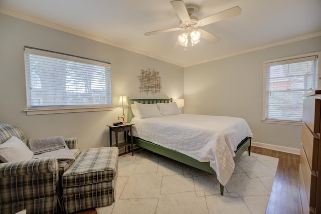 bedroom featuring wood-type flooring, ornamental molding, and ceiling fan