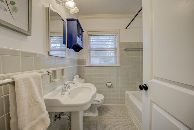 bathroom with tile walls, toilet, tile patterned flooring,  shower combination, and crown molding