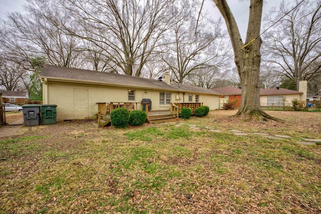 back of house with a yard and a deck