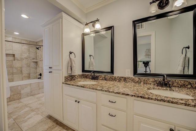 bathroom with crown molding, vanity, and tiled shower / bath combo