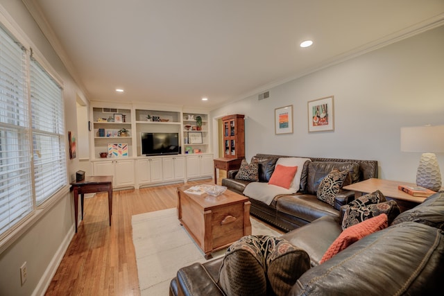 living room with built in features, light hardwood / wood-style flooring, and ornamental molding