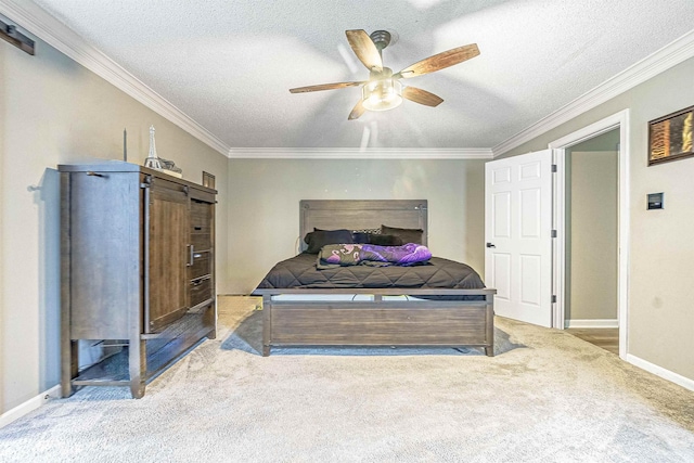 carpeted bedroom with ceiling fan, crown molding, and a textured ceiling