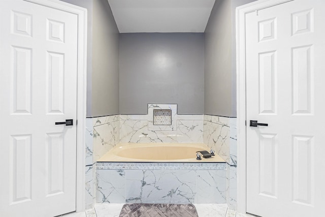 bathroom with tiled tub