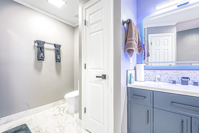 bathroom with crown molding, vanity, and toilet