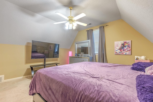 bedroom with light carpet, ceiling fan, vaulted ceiling, and a textured ceiling