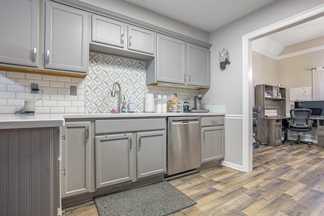 kitchen featuring light hardwood / wood-style flooring, dishwasher, gray cabinetry, backsplash, and ornamental molding