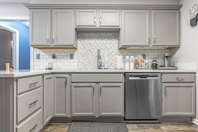 kitchen featuring gray cabinets, dishwasher, hardwood / wood-style flooring, and sink