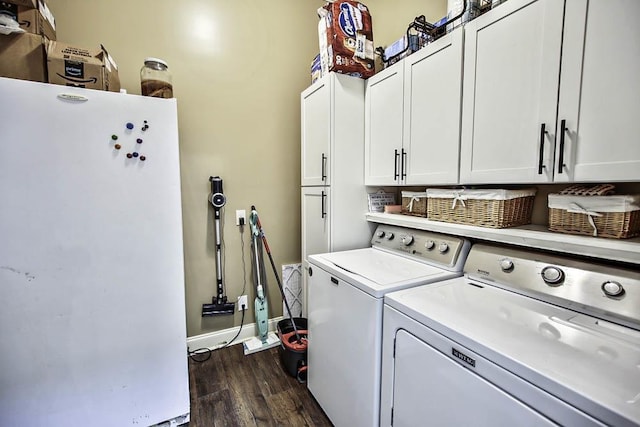 laundry room featuring dark wood-type flooring, cabinets, and separate washer and dryer