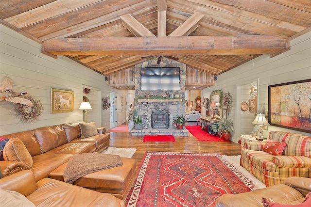 living room with vaulted ceiling with beams, wooden ceiling, wooden walls, a fireplace, and hardwood / wood-style floors