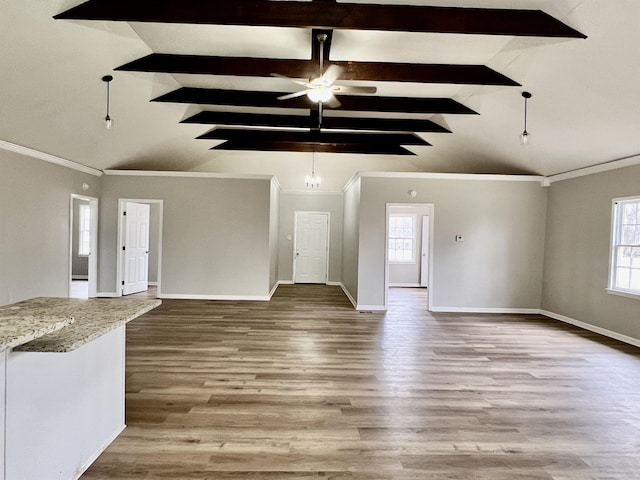 unfurnished living room featuring hardwood / wood-style flooring, crown molding, ceiling fan with notable chandelier, and vaulted ceiling with beams