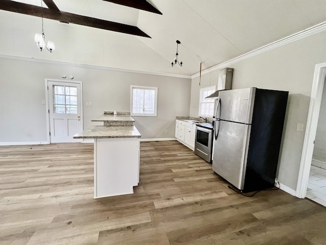 kitchen featuring appliances with stainless steel finishes, white cabinets, a chandelier, hanging light fixtures, and wall chimney range hood