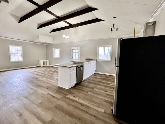 kitchen featuring hanging light fixtures, stainless steel appliances, light stone counters, white cabinets, and light wood-type flooring