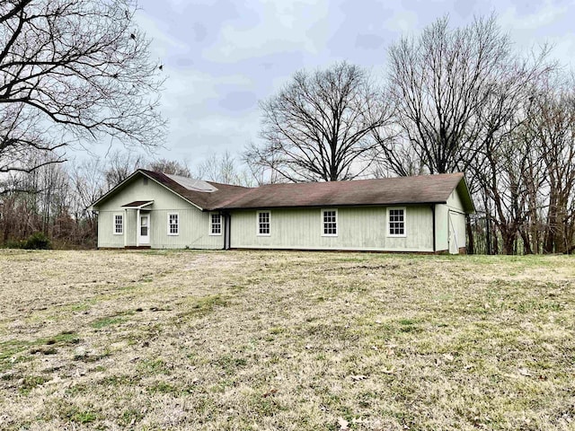 rear view of property with a lawn