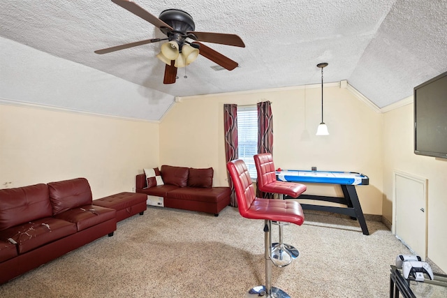 recreation room featuring lofted ceiling, carpet flooring, and a textured ceiling